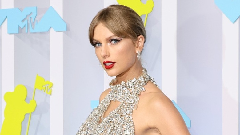 Taylor Swift on the red carpet in a dress made of crystal