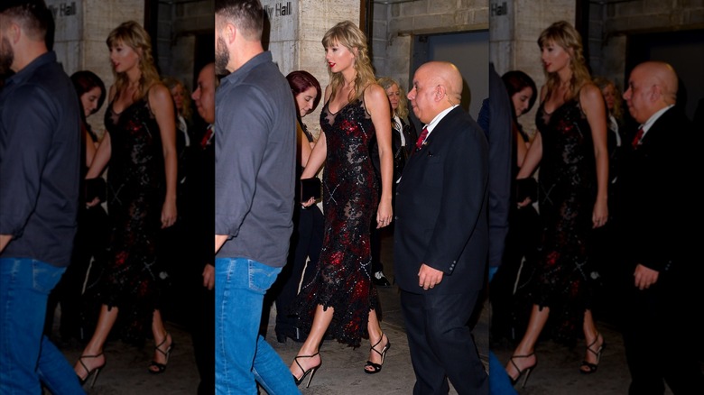 Paparazzi shot of Taylor Swift walking in a black dress