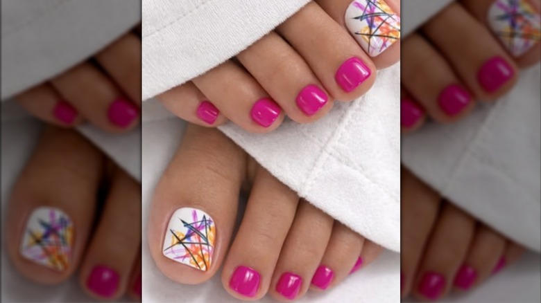 female feet with pink and abstract art polish