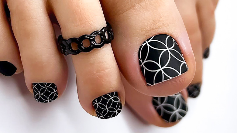 feet with geometric art nail polish