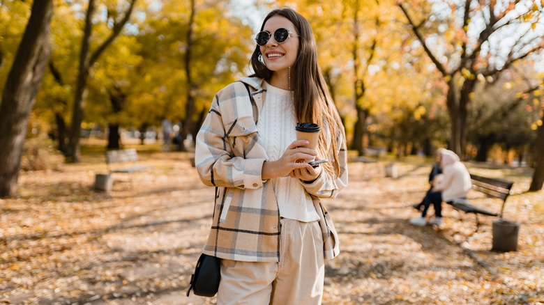 Woman wearing fall fashion crossing street