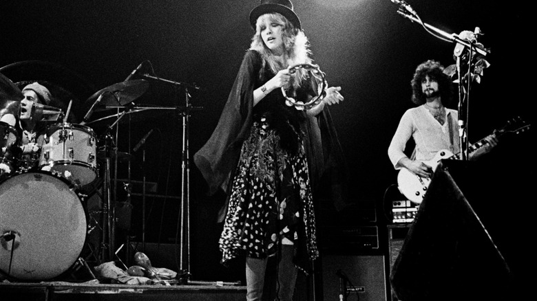 Stevie Nicks on stage with Fleetwood Mac band, 1975