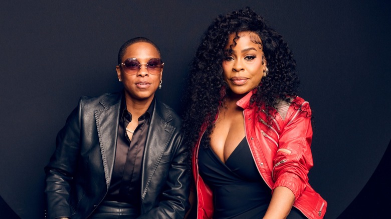 Niecy Nash and Jessica Betts posing together in front of a black background