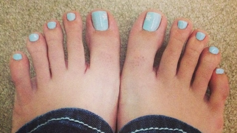 Feet with a blue snowflake pedicure
