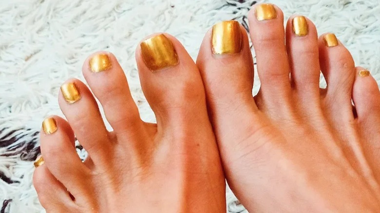 Feet with a metallic gold manicure