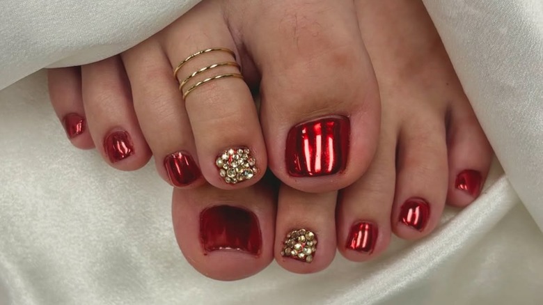 Feet with a chrome and rhinestone pedicure