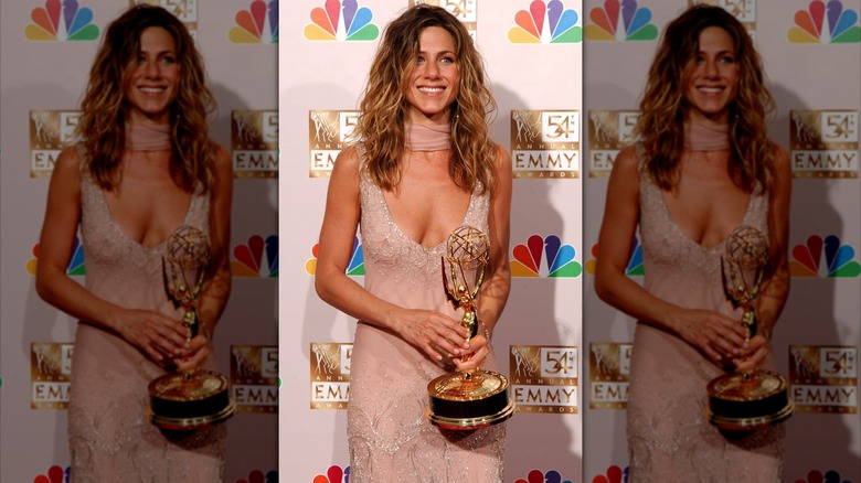 Jennifer Aniston in a peach dress with a matching scarf in 2002
