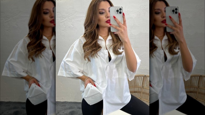 Woman posing in an oversized white shirt