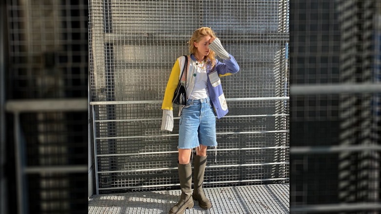 Girl in oversized jean shorts and chunky boots