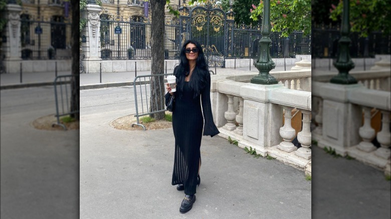 Woman wearing a black dress and loafers