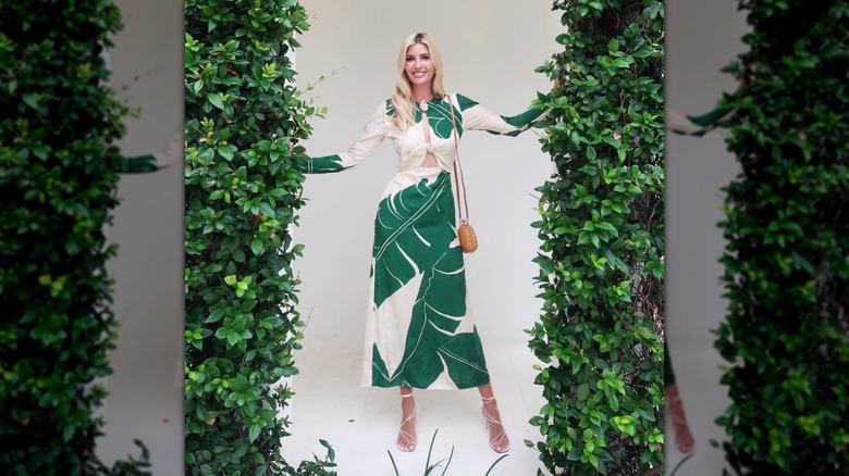 Ivanka Trump posing next to walls of leaves in Miami