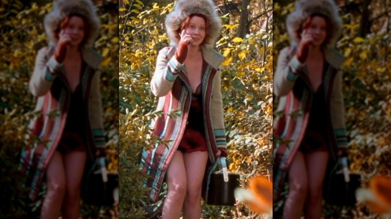 Cynthia Nixon as Miranda Hobbs Jones outside in a coat, hat, and slip