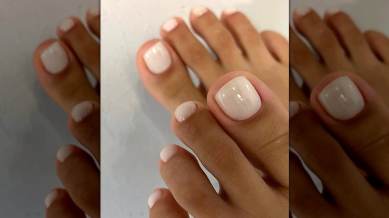 A woman with a light white pedicure