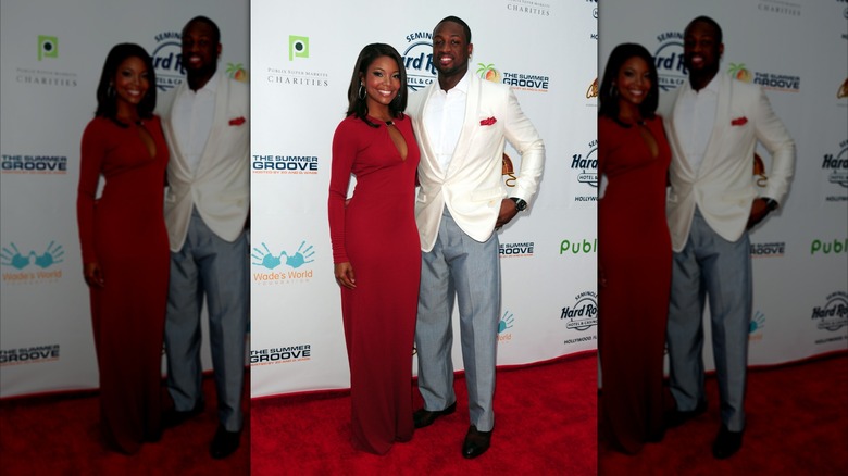 Gabrielle Union and Dwyane Wade smiling into the camera with an arm around one another