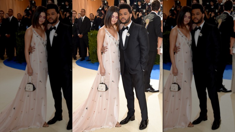Selena Gomez leaning her head against The Weeknd's as the two pose at the Met Gala