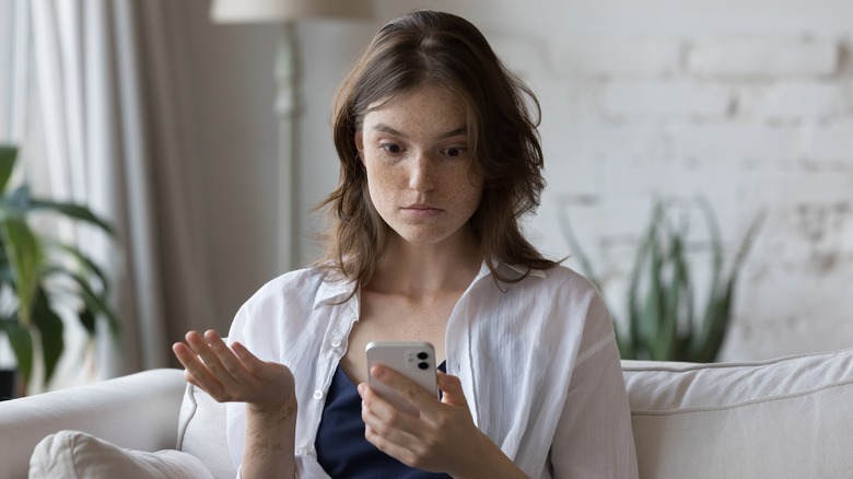 Woman annoyed with her phone