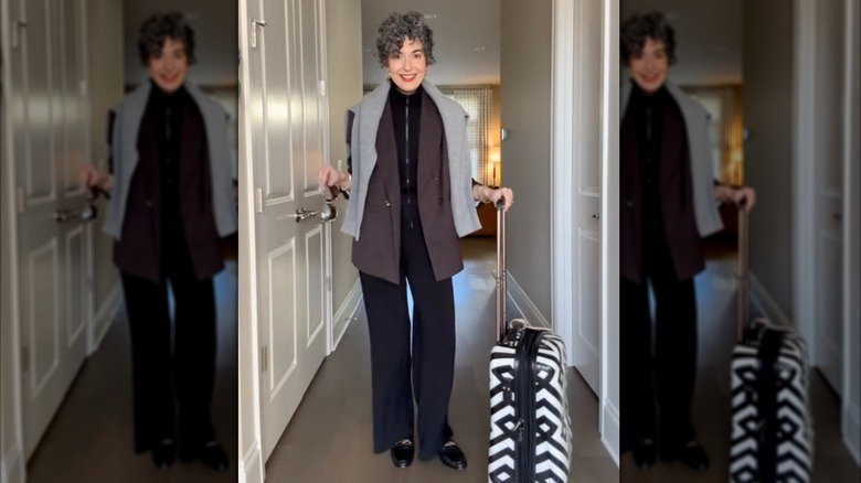 A woman in brown and black traveling clothes with black loafers