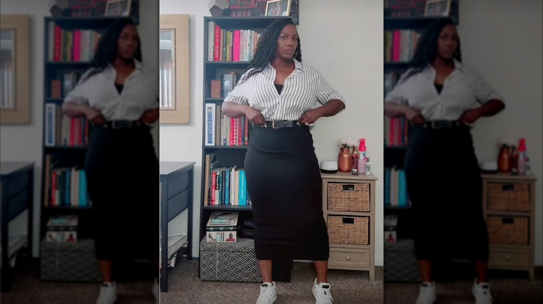 A woman wearing a stretchy skirt with a black and white shirt and sneakers