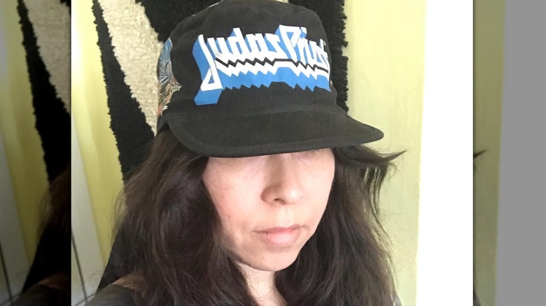 A woman models one of her old painter's caps from the '80s