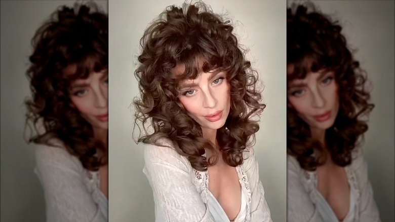 A woman on TikTok styling her hair in an 80s perm
