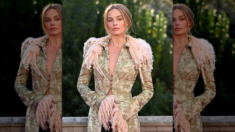 Margot Robbie wearing a floral patterned blazer with pink lapels