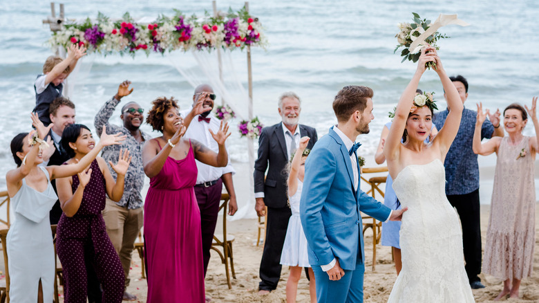 Wedding guests throwing flowers