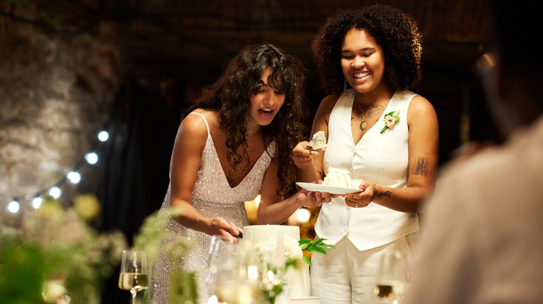 Queer newlyweds cutting cake