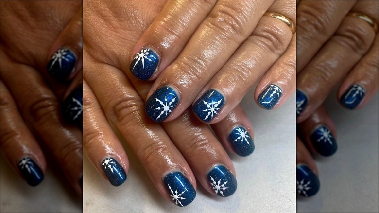 Dark blue snowflake manicure