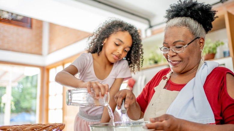 A granddaughter and grandmother baking together