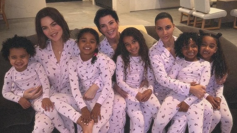 Kris Jenner posing in matching pajamas with Khloe Kardashian, Kim Kardashian, and her grandchildren