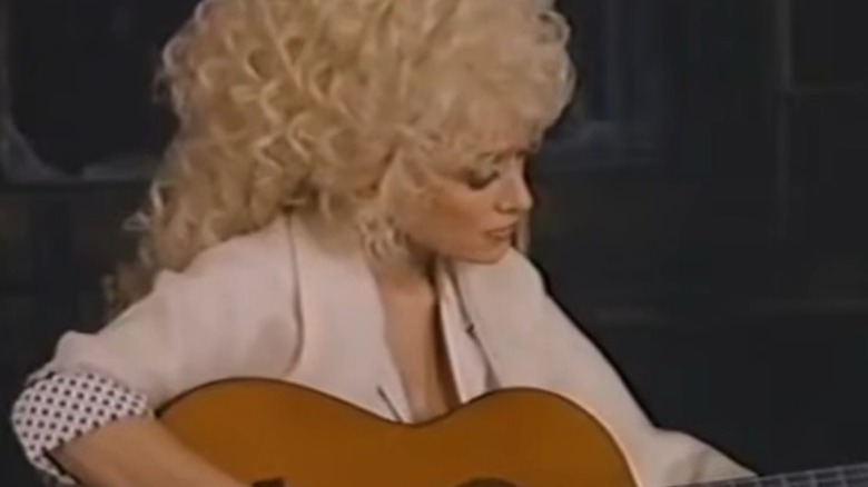 Dolly Parton playing guitar in "A Smoky Mountain Christmas"