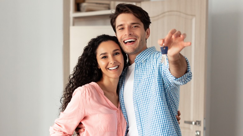 Couple holding house keys