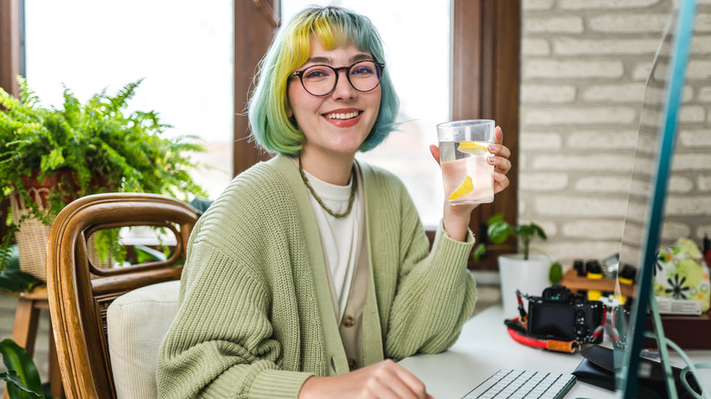 Woman holding water smiling