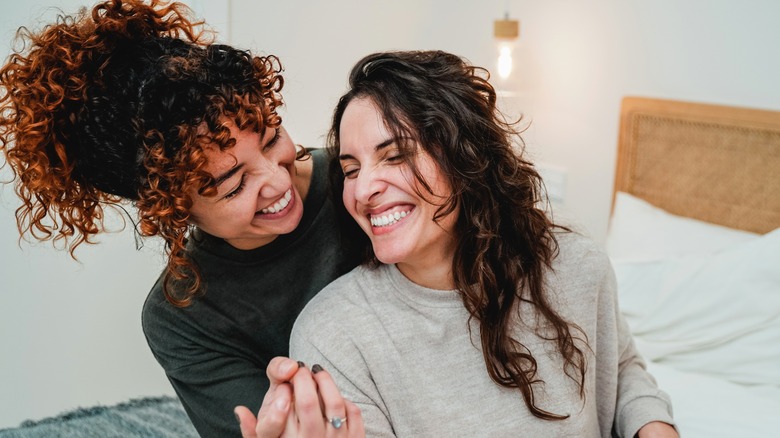 Couple embracing & laughing