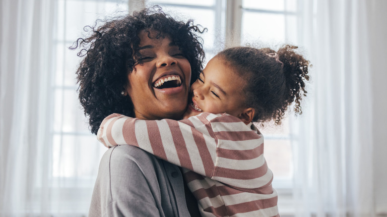 Girl hugging woman & laughing