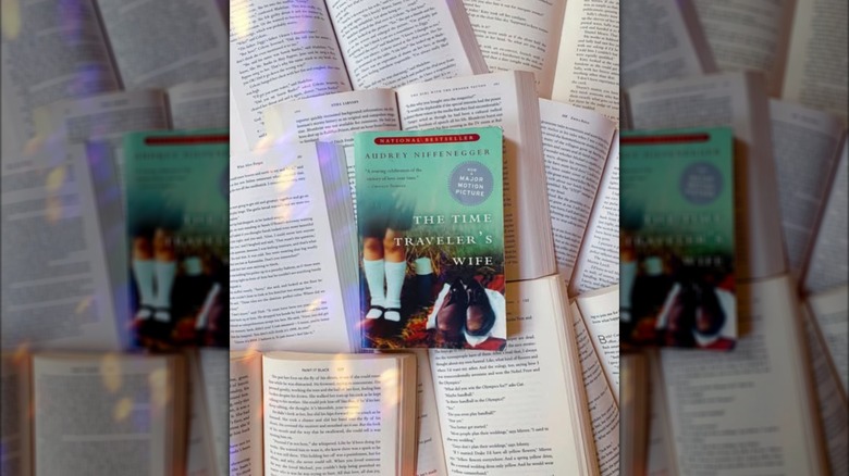 A copy of the novel "The Time Traveler's Wife" laying on a stack of other open books