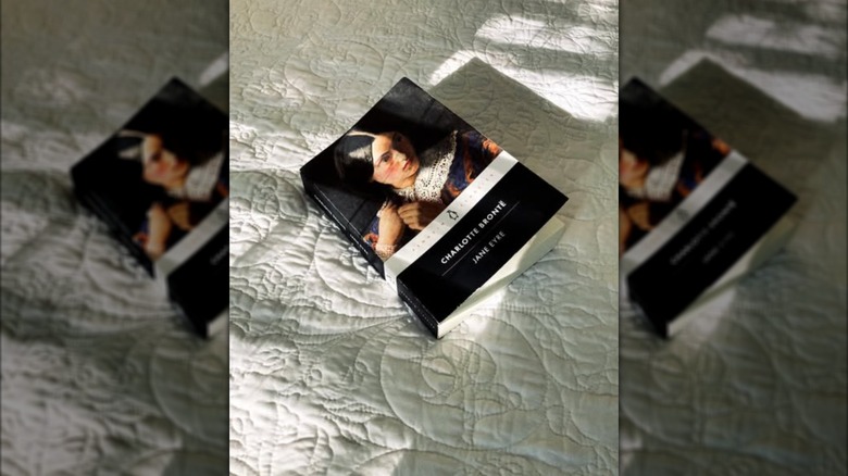 A copy of the novel "Jane Eyre" laying on a bed
