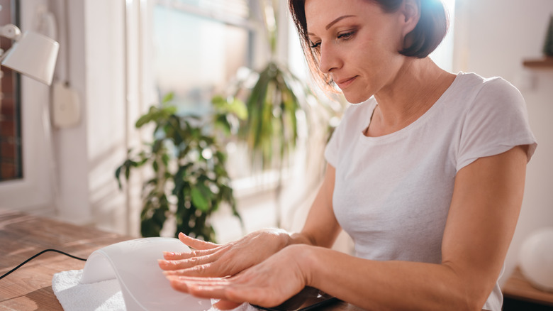 woman looking at her nails