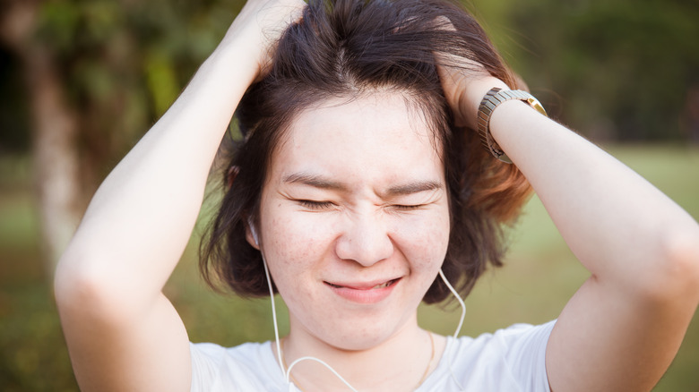 Woman itching her head
