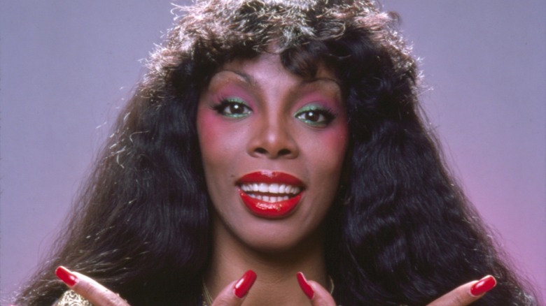 Donna Summer posing with colorful makeup and long, red nails during a 1978 photo shoot