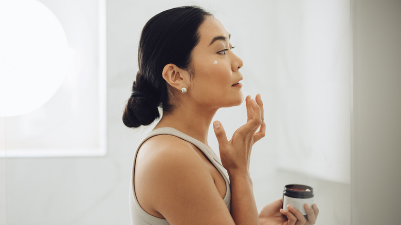 Woman moisturizing