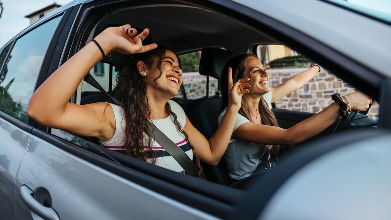 Two girls making a hand heart