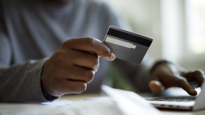 person holding credit card