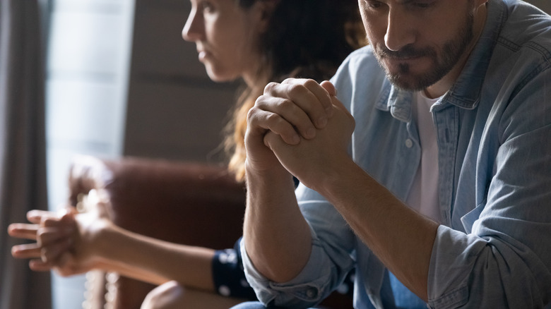 man and woman facing away from each other