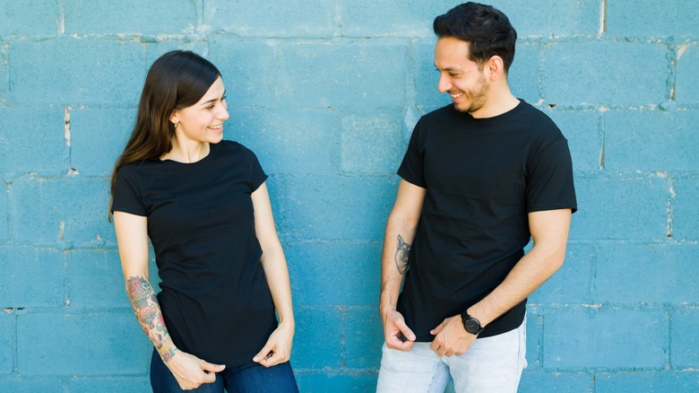 man and woman wearing matching outfits