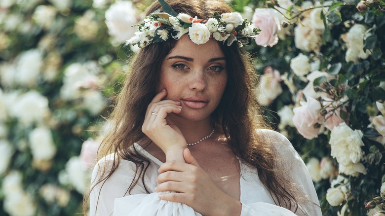 Bride standing by flowers