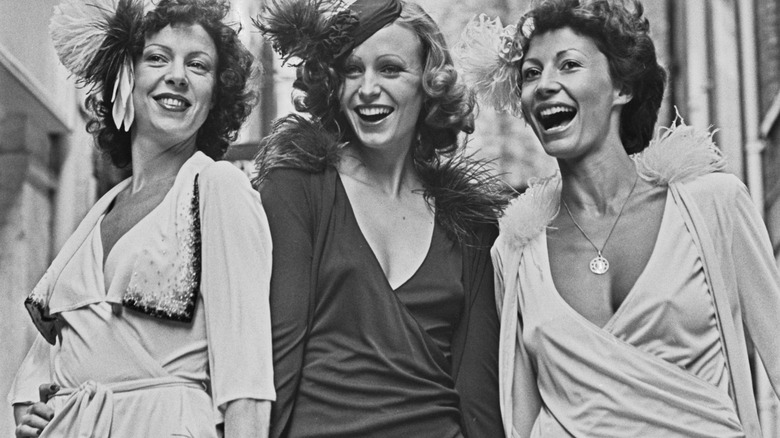 Three women wearing wrap dresses in 1973