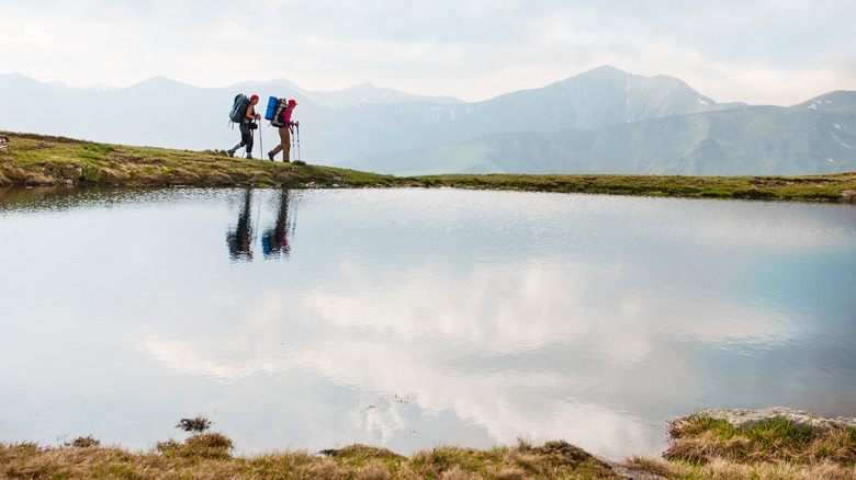 Friends hiking around a lake 