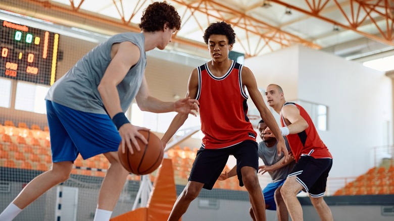 Two teams playing basketball in a gymnasium