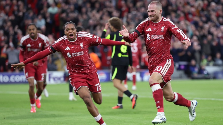 Liverpool football club players celebrating a goal on the soccer pitch